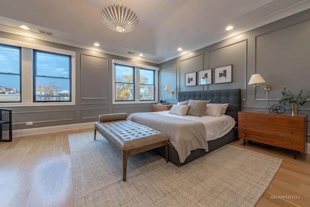 bedroom with vaulted ceiling and light hardwood / wood-style floors