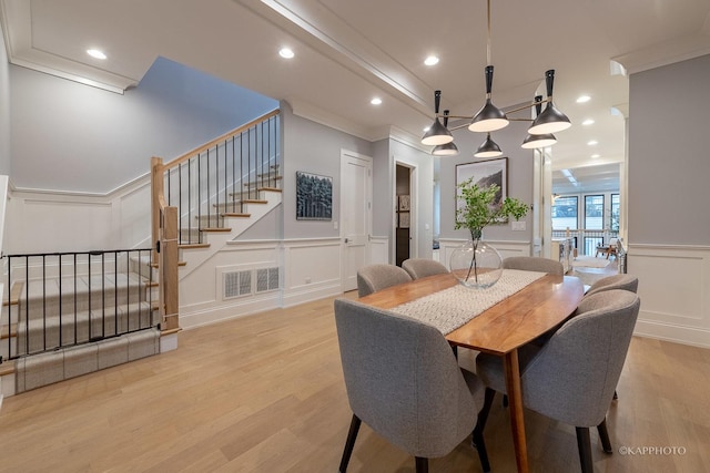 dining room featuring crown molding and light wood-type flooring