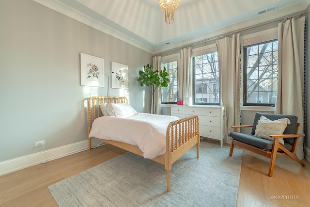 bedroom featuring multiple windows and light hardwood / wood-style flooring