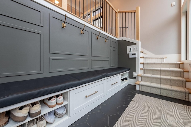 mudroom featuring dark tile patterned floors