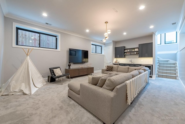 living room featuring crown molding and light carpet