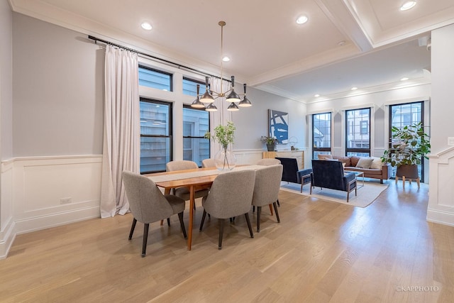 dining area featuring crown molding, light hardwood / wood-style floors, and beamed ceiling