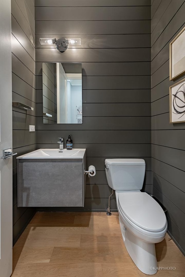 bathroom featuring vanity, toilet, and hardwood / wood-style floors