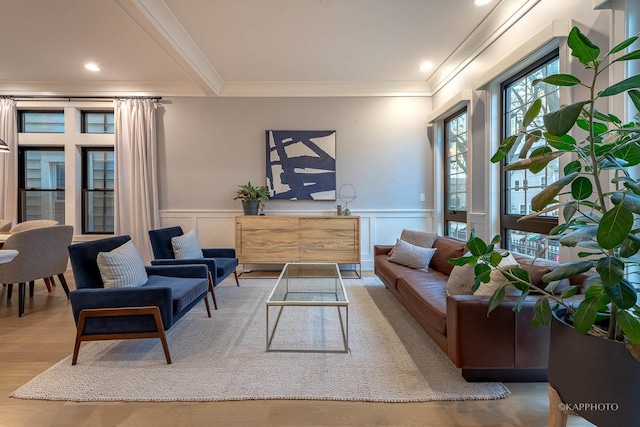 living room with hardwood / wood-style flooring and ornamental molding