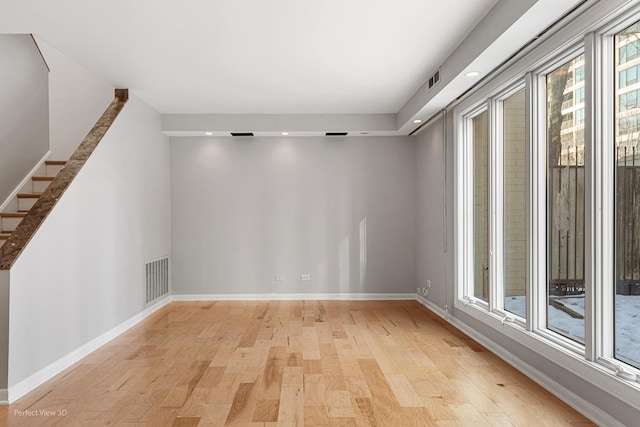 empty room with light hardwood / wood-style flooring