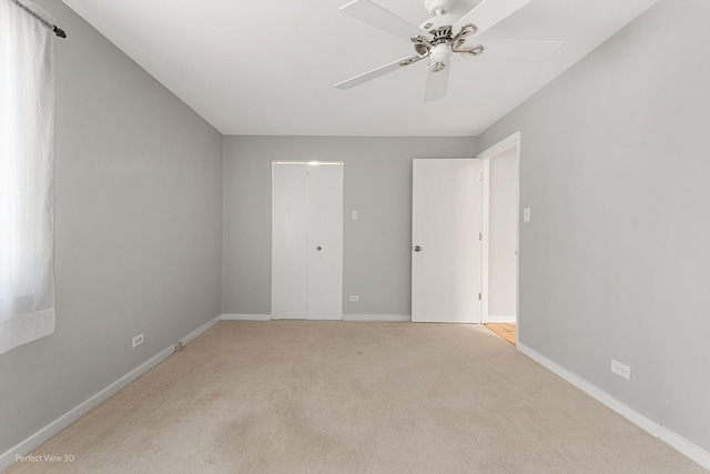 unfurnished bedroom with ceiling fan and light carpet