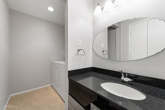 bathroom with vanity and washing machine and clothes dryer