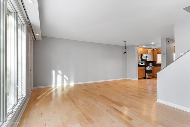 unfurnished living room featuring light wood-type flooring