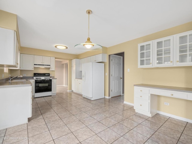 kitchen with sink, white appliances, white cabinetry, hanging light fixtures, and built in desk