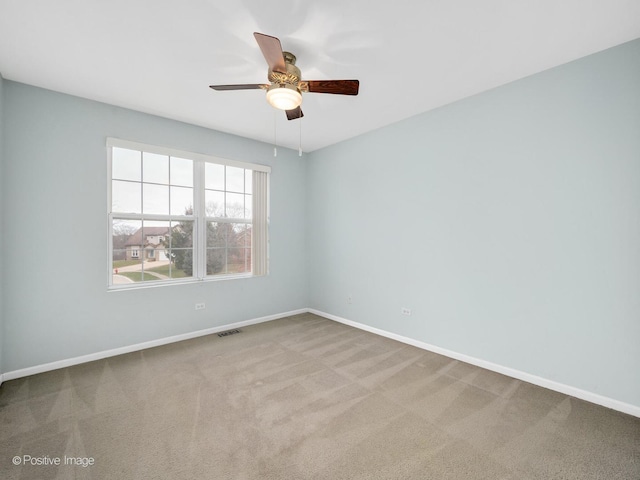 unfurnished room featuring ceiling fan and carpet