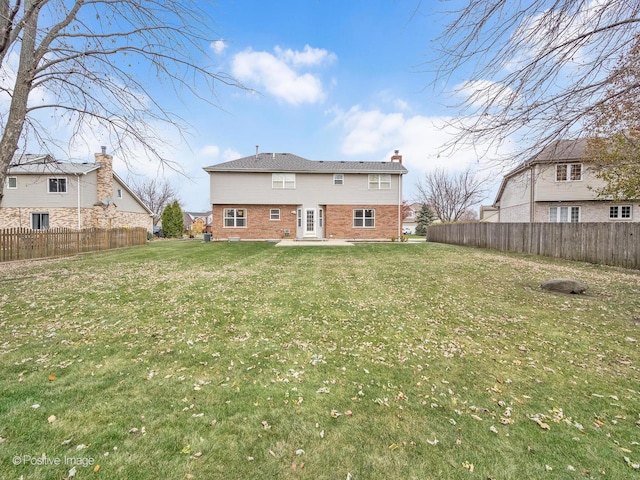 back of house featuring a yard and a patio area