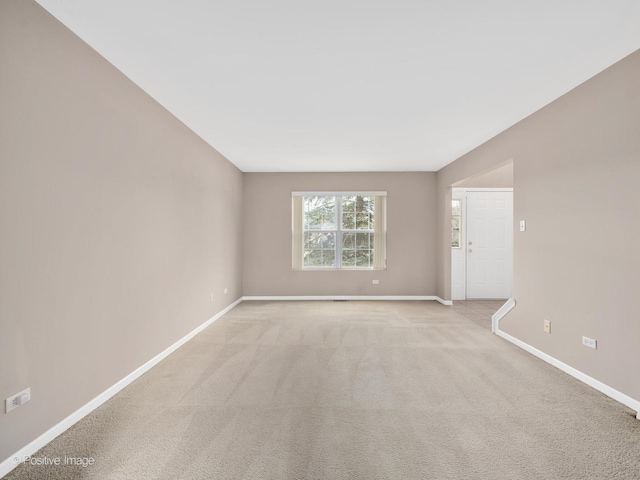 unfurnished room featuring light carpet