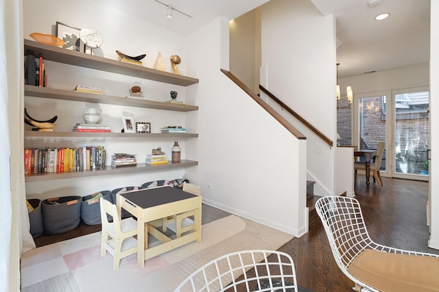 interior space featuring recessed lighting, wood finished floors, rail lighting, and baseboards