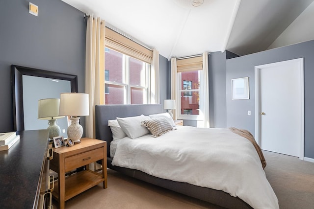 bedroom featuring vaulted ceiling and carpet floors