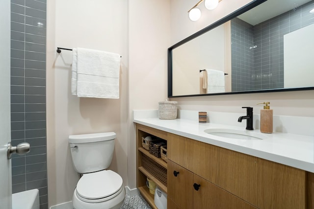 bathroom with toilet, a shower, and vanity