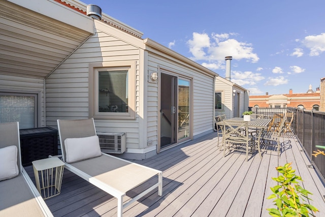 wooden deck featuring cooling unit and outdoor dining area