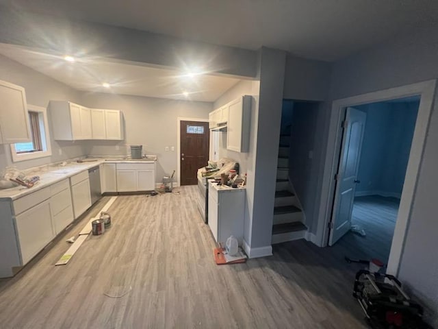 kitchen with white cabinetry, appliances with stainless steel finishes, and light hardwood / wood-style flooring