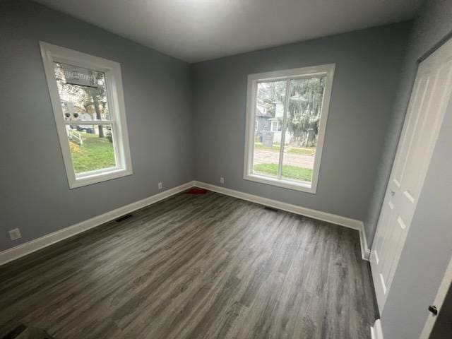 spare room with dark hardwood / wood-style floors