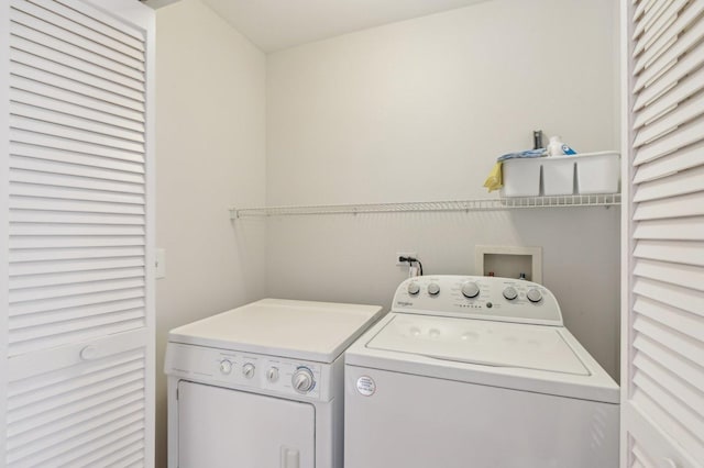 clothes washing area featuring washer and clothes dryer