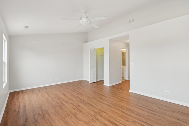 spare room featuring ceiling fan, lofted ceiling, and light hardwood / wood-style flooring