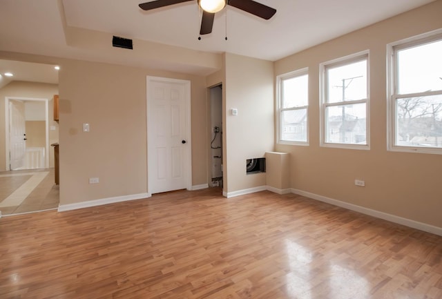 empty room with ceiling fan and light wood-type flooring