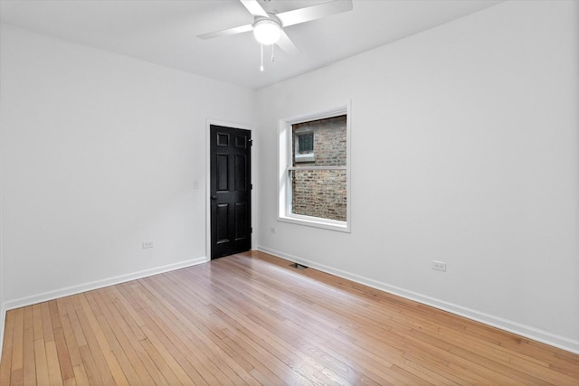 empty room featuring ceiling fan and light wood-type flooring