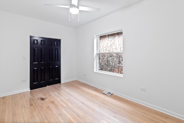 spare room featuring ceiling fan and light hardwood / wood-style floors