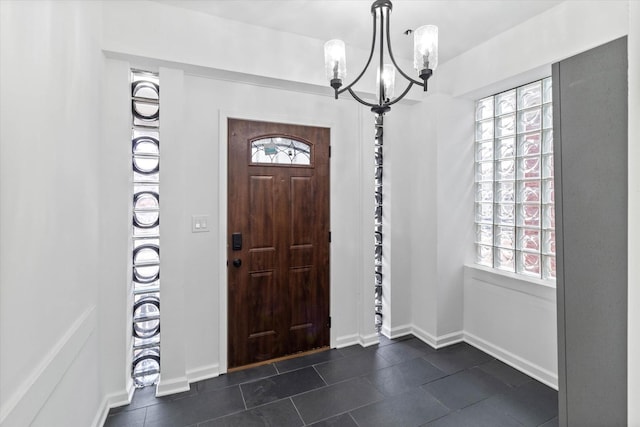 entrance foyer featuring a healthy amount of sunlight and a notable chandelier