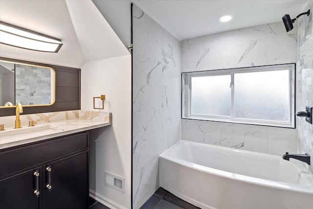 bathroom with vanity and tiled shower / bath combo