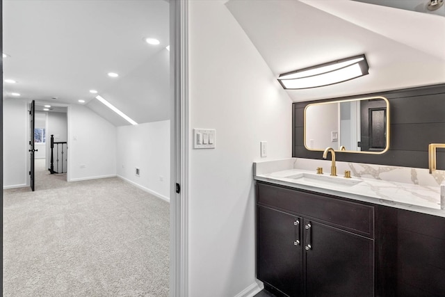 bathroom featuring vanity and vaulted ceiling