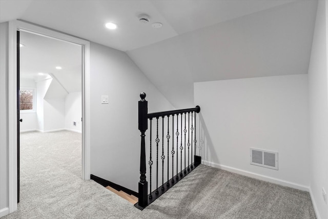 staircase with lofted ceiling and carpet flooring