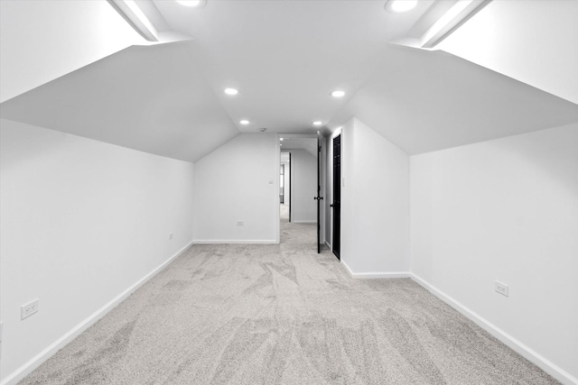 bonus room featuring vaulted ceiling and light carpet