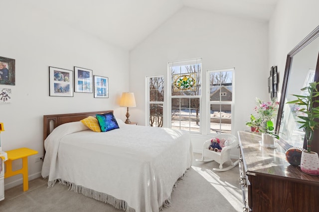 carpeted bedroom featuring lofted ceiling