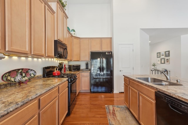 1616 Colchester Ln, Aurora, IL 60502 - kitchen with black appliances, a sink, light wood-type flooring, light brown cabinets, and a high ceiling