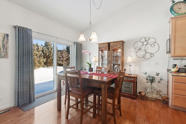 1616 Colchester Ln, Aurora, IL 60502 - dining space featuring a chandelier, wood finished floors, and vaulted ceiling