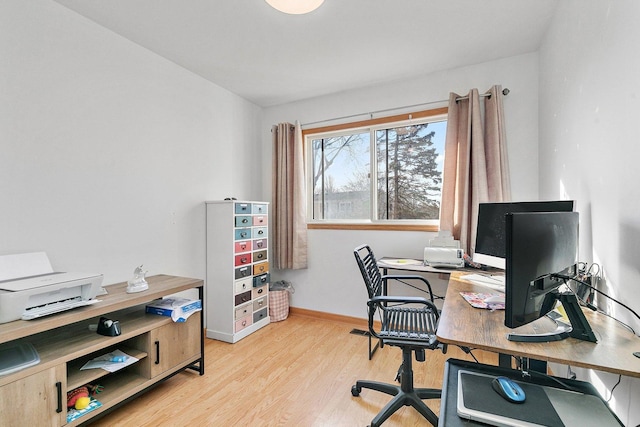 office space featuring light wood-style floors and baseboards