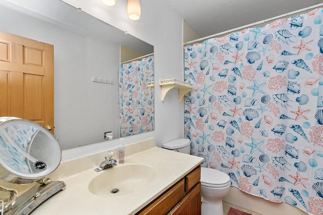 bathroom featuring vanity and toilet