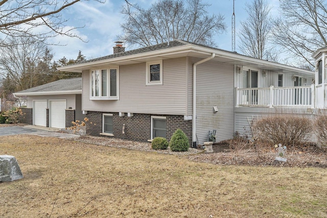 view of property exterior with a garage and a lawn