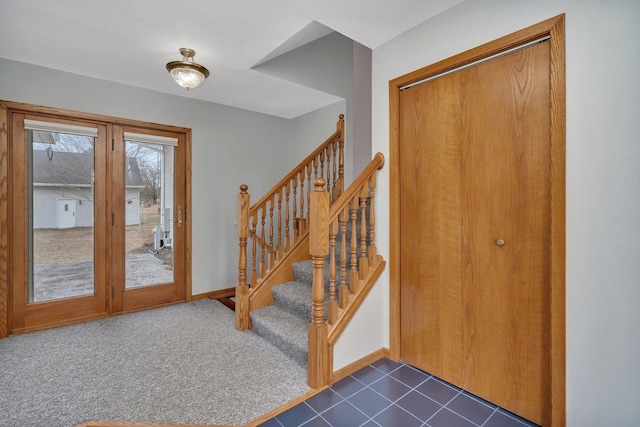 entrance foyer with dark carpet