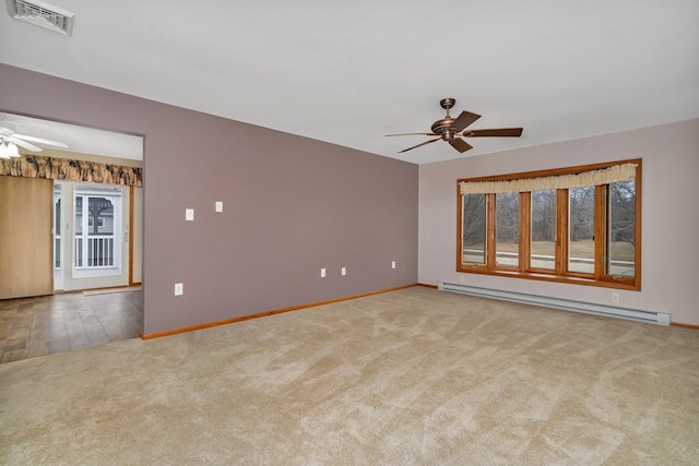 carpeted empty room featuring a baseboard radiator, a healthy amount of sunlight, and ceiling fan