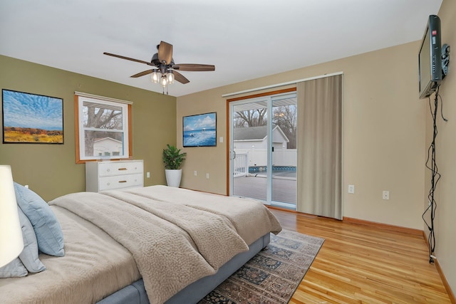 bedroom featuring access to exterior, light hardwood / wood-style floors, and ceiling fan