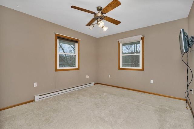 empty room with a baseboard radiator, light colored carpet, and ceiling fan