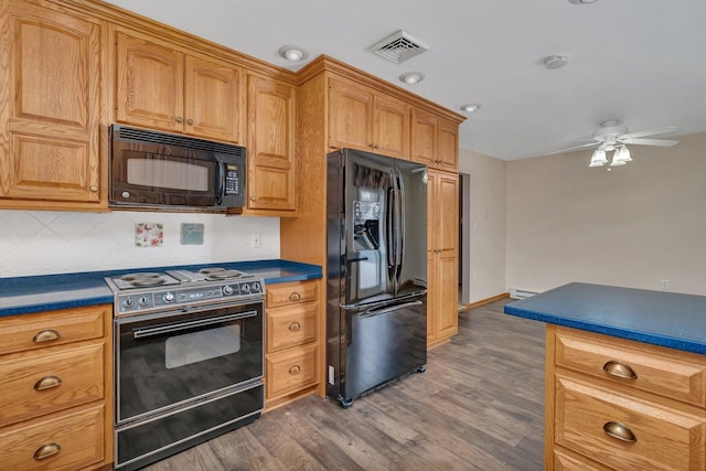 kitchen with dark hardwood / wood-style floors, a baseboard radiator, backsplash, ceiling fan, and black appliances