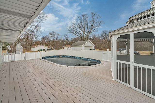 wooden deck featuring a covered pool