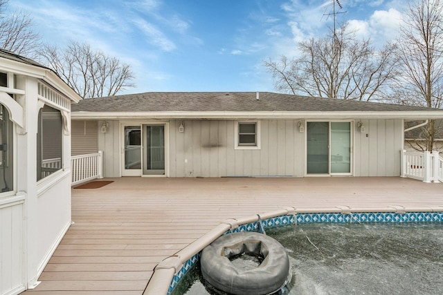 exterior space with a pool and an outdoor fire pit