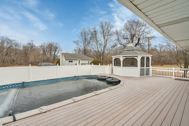 wooden terrace with a gazebo and a covered pool