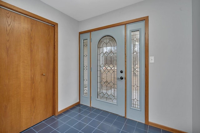 foyer with dark tile patterned floors