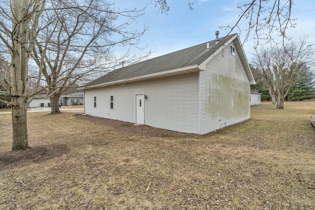 view of side of property with a lawn