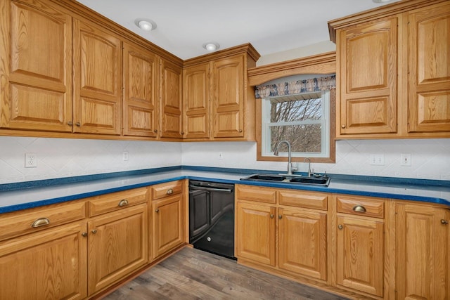 kitchen with tasteful backsplash, wood-type flooring, black dishwasher, and sink