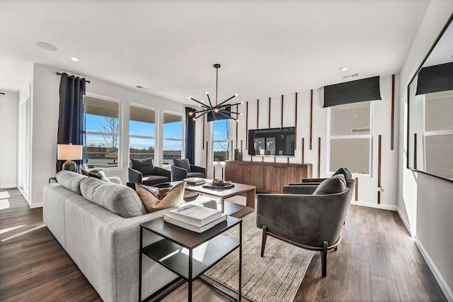 living room with an inviting chandelier and dark hardwood / wood-style floors